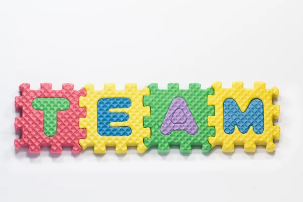Puzzle pieces with word team — Stock Photo, Image