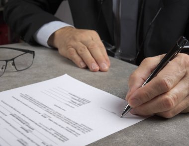 Business man signing  a contract making a deal, classic business concept