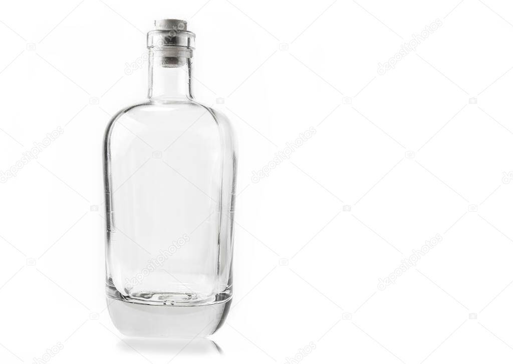 Empty glass bottle with cork on the white background