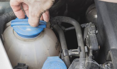 Araba radyatör soğutucu seviyesi kontrol ediliyor ve liqiud ekleniyor.