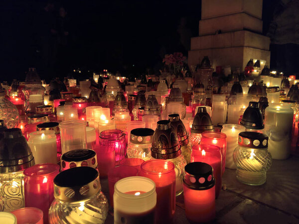 Candels lit during all saints night or halloween at european  cemetery