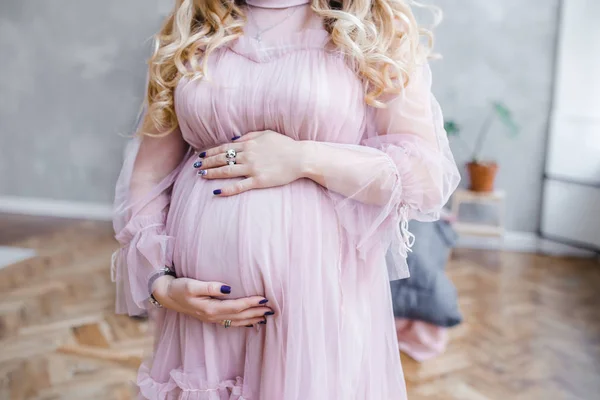 A gentle photo of the belly of a pregnant girl. expecting a baby preparing for childbirth — Stock Photo, Image