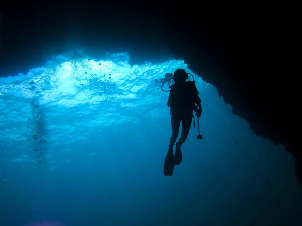 Mergulhador silhueta em uma caverna — Fotografia de Stock