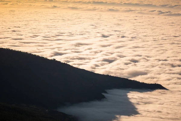 sea of clouds below the summit of Teide volcano in Tenerife