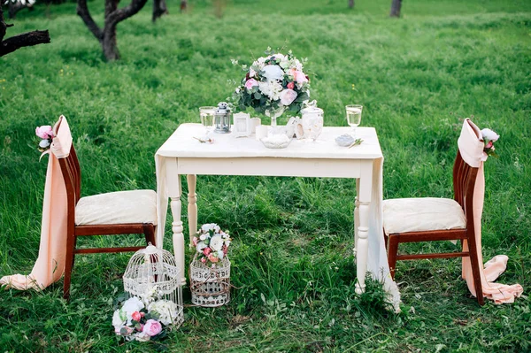 Decorated table served for two in the garden. Romantic dating Stock Picture