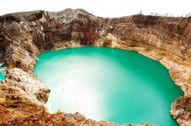 Kelimutu National Park in Indonesia. Colored lakes in Kelimutu volcano crater, Flores.  clipart