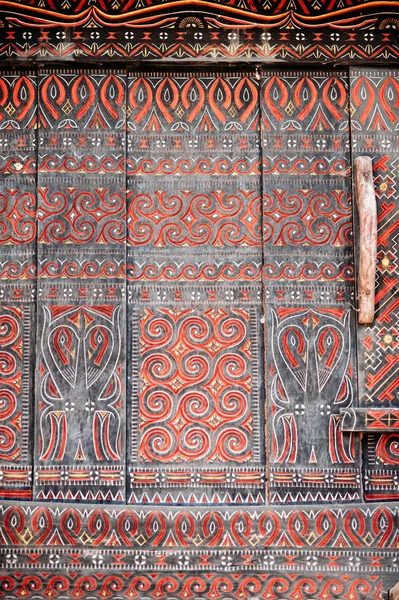 Wall of torajan building tongkonan with traditional carving. Tana Toraja, Rantepao, Sulawesi, Indonesia. Royalty Free Stock Photos