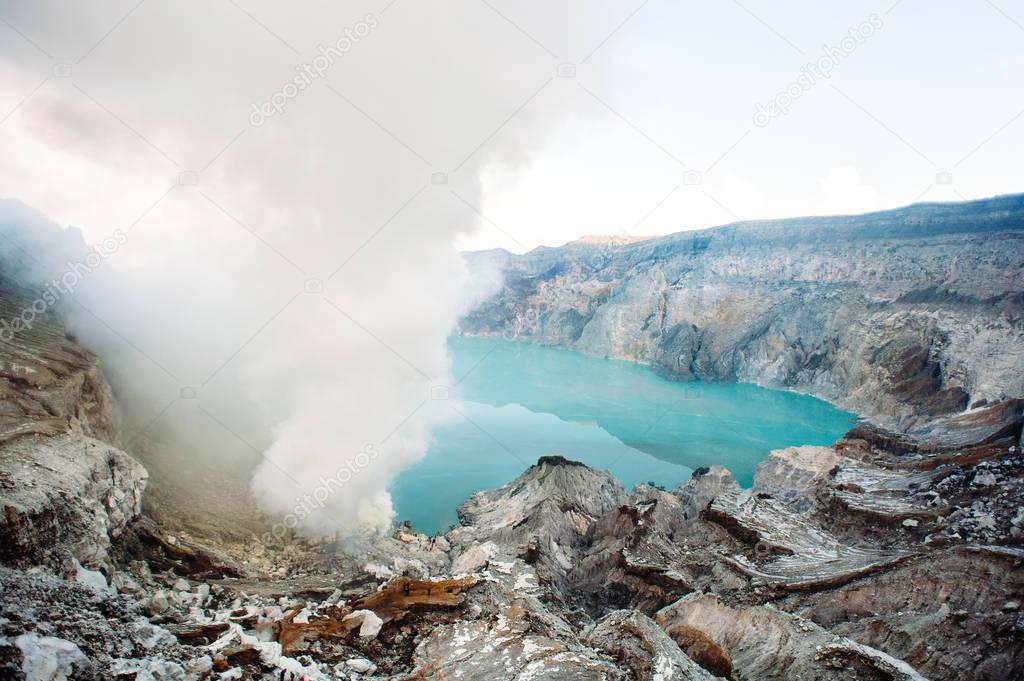 Kawah Ijen Volcano, East Java, Indonesia. Blue sulphurous lake with evaporation in the crater of a volcano, a unique and dangerous place on Earth