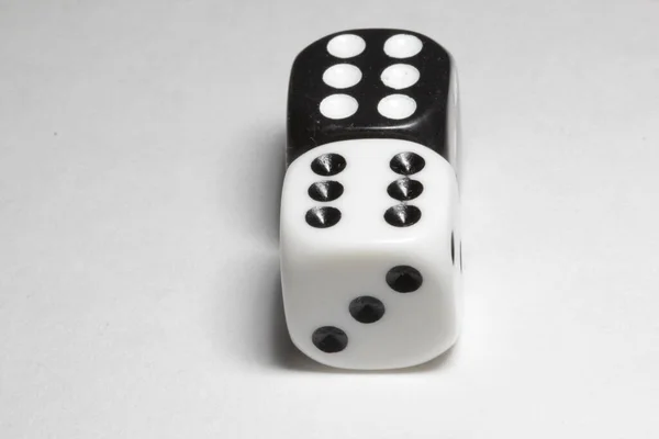 Two dice on a white background. White and black dice on a white background. Isolated dice close up
