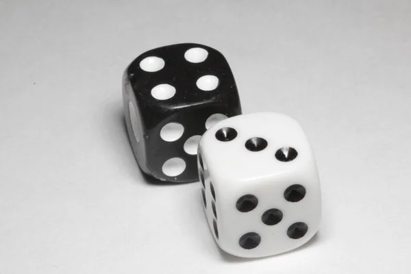 Two dice on a white background. White and black dice on a white background. Isolated dice close up