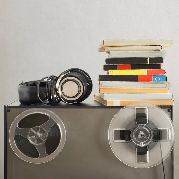 Vintage magnetic audio reels and headphones on the analog tape recorder