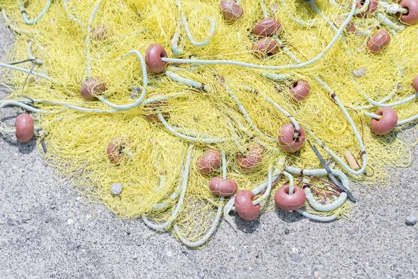 Yellow fishing net on the quay — Stock Photo, Image