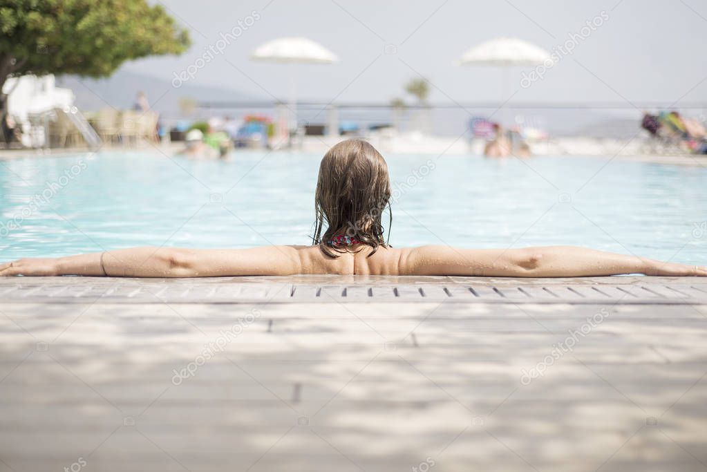 Woman relaxing in swimming pool