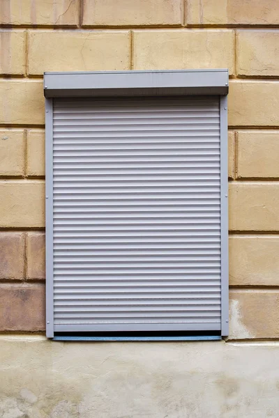 Fenster mit Rollläden an der Wand Stockbild