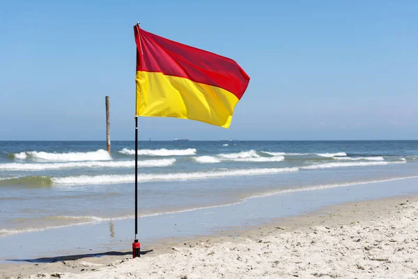 Red and yellow warning sign flag — Stock Photo, Image
