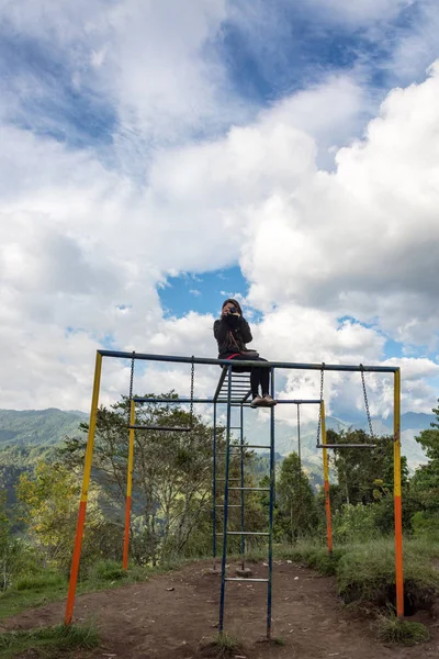 Woman on a Jungle Gym — Stock Photo, Image