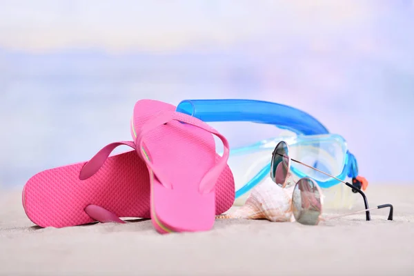 Flip flops with diving goggles and sunglasses