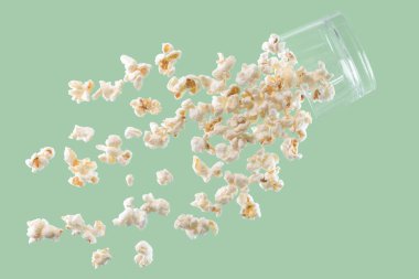 Delicious looking popcorn falling from a glass