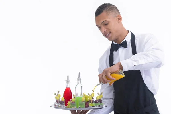 Waiter mixing liquor in glass shots with grapes — Stock Photo, Image