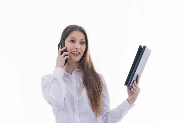 Formal businesswoman holding a tablet and talking on her phone — Stock Fotó