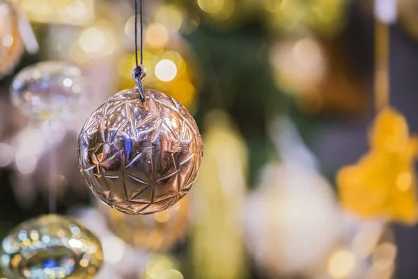 Christmas decorations on the branches fir. Beautiful copper christmas ball — Stock Photo, Image