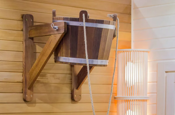 Traditional wooden sauna for relaxation with bucket of water. Interior of sauna and sauna accessories. — Stock Photo, Image