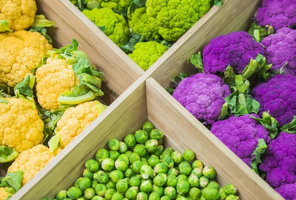 Fresh colorful vegetables on the counter of the store: colorful cauliflower, Brussels sprouts
