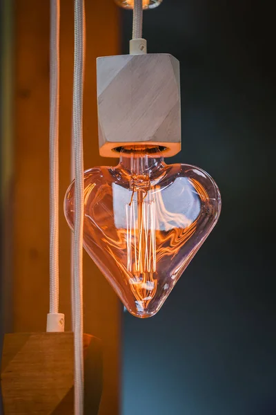 Eine schöne edison-glühbirne in form eines herzens. festlich süßer Kronleuchter in Herzform — Stockfoto