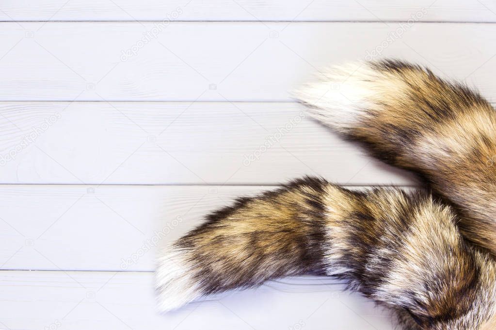 Tails of a fox on a wooden background. Skins of red fox