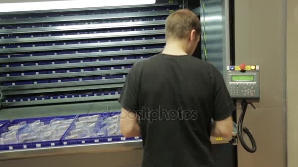 Mężczyzna Robotnik Zautomatyzowane Karuzela Pionowe Jednostki Przechowywania Magazynie — Wideo stockowe