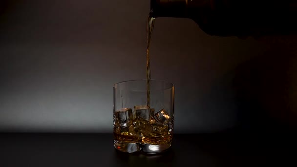 Short Film Showing Whiskey Being Poured Tumbler Glass Ice Black — Stock Video