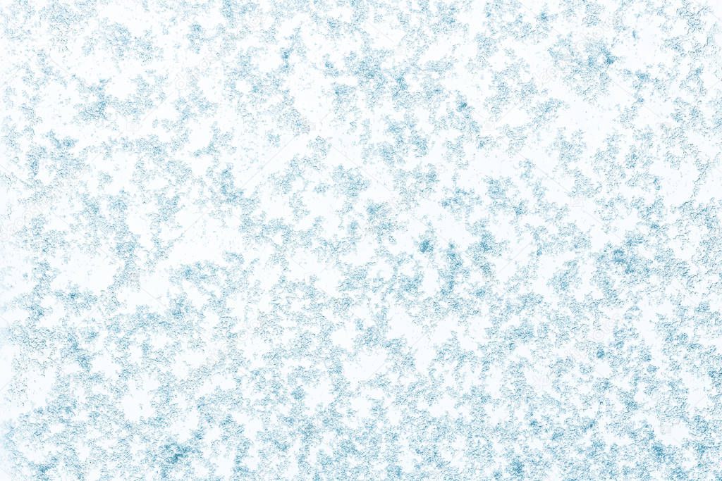Beautiful close up view of natural snow pattern on light blue background. Beautiful backgrounds texture. 