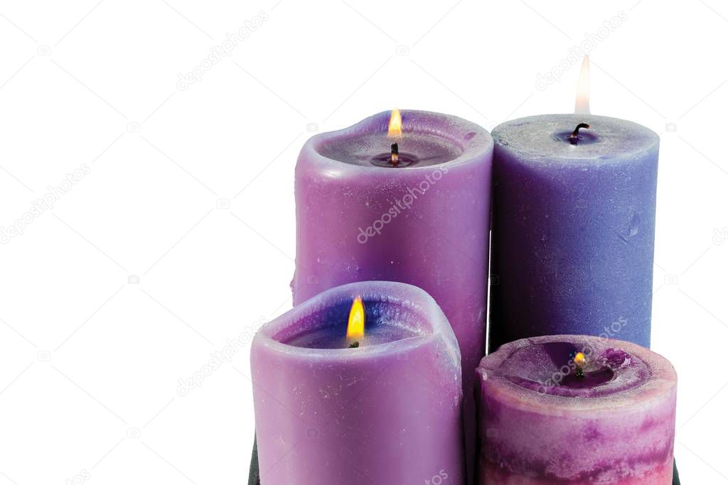 Close up view of four purple thick candles. Romantic concept.