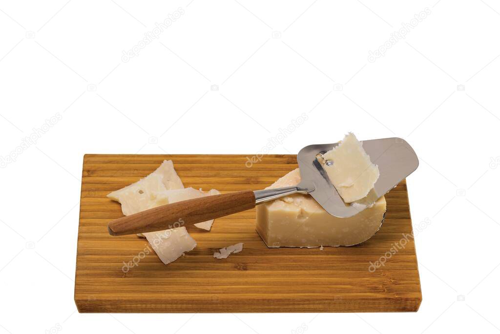 Close up view of cheese with cheese knife isolated on wooden board. Healthy food concept.