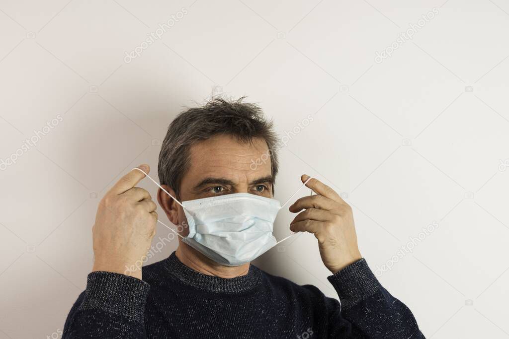 Close up view of man in white face mask. oronavirus pandemic concept. Influenza virus concept. 