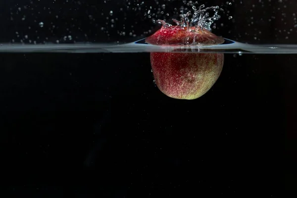 Закройте Вид Цветного Яблока Падающего Воду Чёрном Фоне Великолепный Фон — стоковое фото