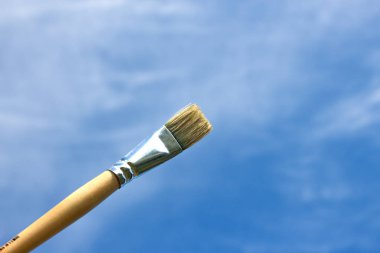 Mavi gökyüzü arka planda izole boya fırçası