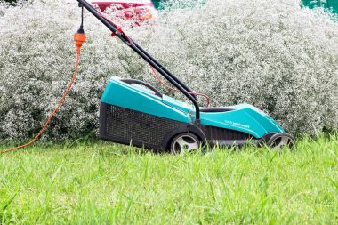 Lawn Mower in garden clipart