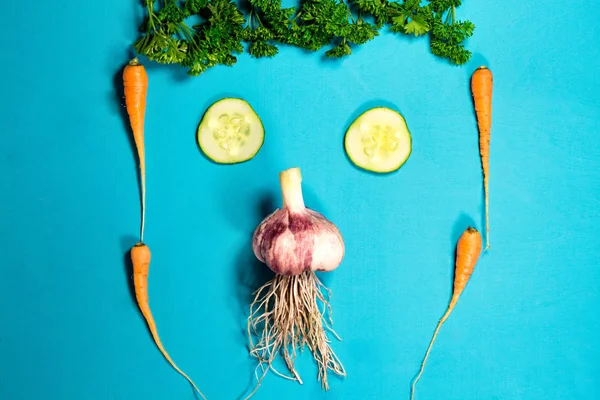 Vegetable funny face. Fresh organic Vegetables on Wooden table. Healthy Vegetarian food, View from above.