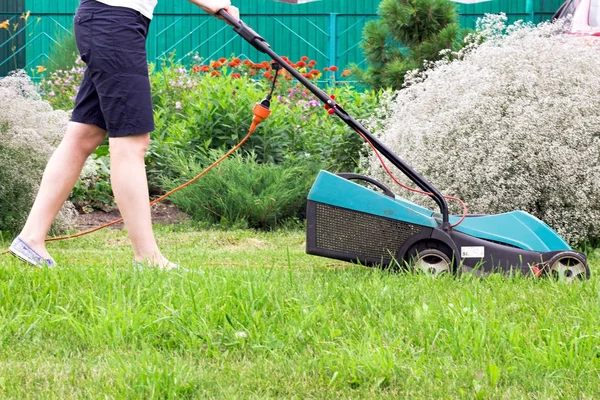 Lawn Mower at Work in garden