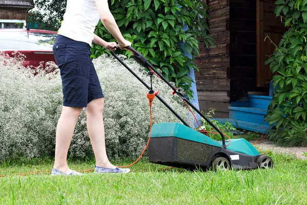 Lawn Mower at Work in garden