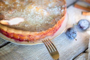 bıçak ve çatal Beyaz ahşap zemin üzerinde rustik erikli kek