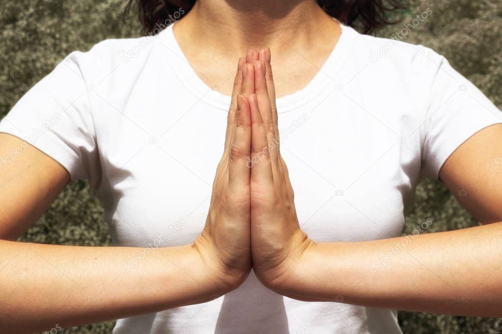 Woman praying hands together, namaste, yoga