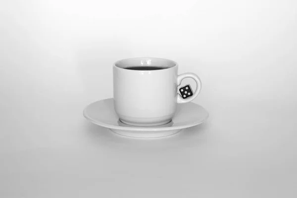 A cup of coffee with dice on white background — Stock Photo, Image