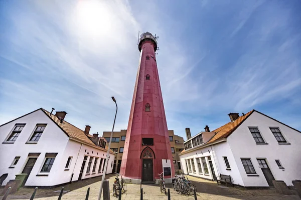 Entire and complete view of the Scheveningen red lighthouse surr