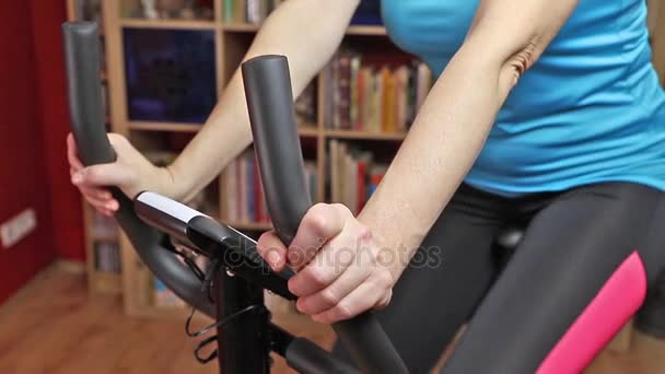 サイクリング自転車トレーナー (エアロバイク) クローズ アップの女性 — ストック動画