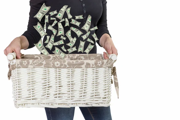 Woman is holding basket with falling US dollar bills — Stock Photo, Image