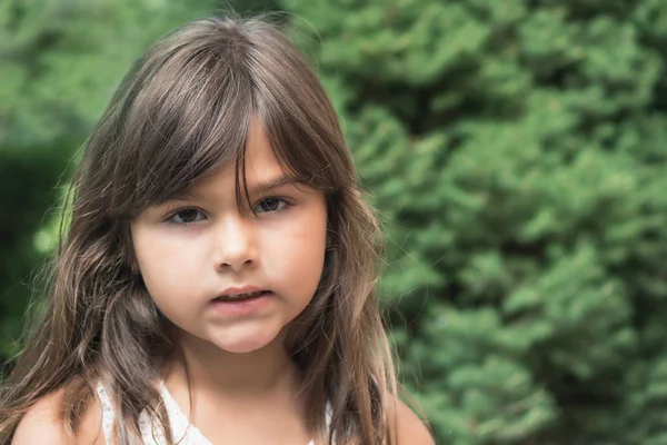 Angry little girl with long hair — Stock Photo, Image