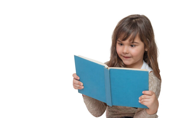Front view of surprised little girl reading a book