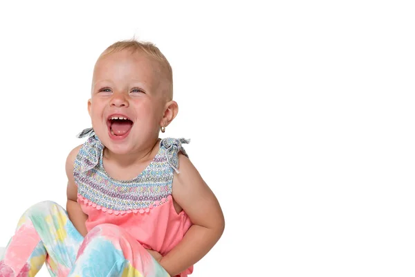 Sitting and laughing toddler girl — Stock Photo, Image